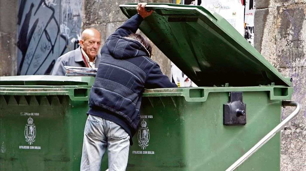 Un cidadán buscando comida nun contedor do lixo en Vigo. (Foto: Nós Diario)