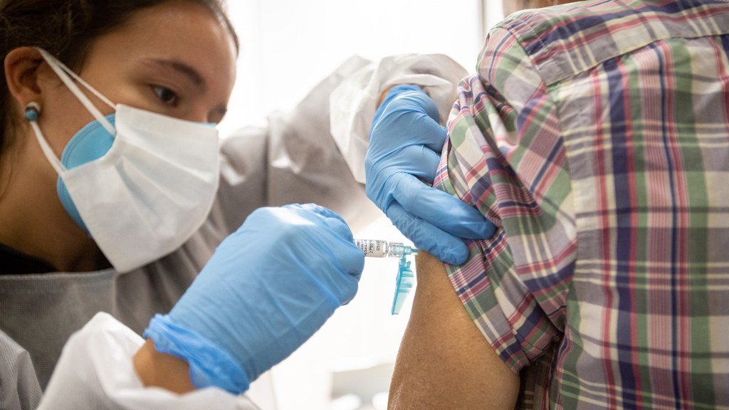Unha enfermeira inxecta a vacina da gripe a un paciente  no inicio da campaña (Iñaki Berasaluce / Europa Press).