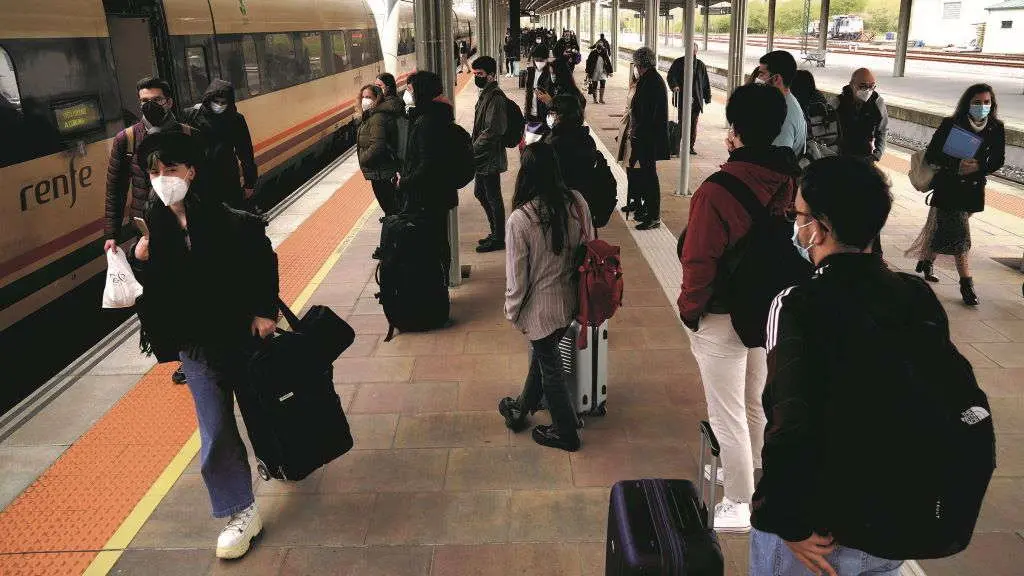 Varias persoas esperan o tren na estaci&oacute;n de Compostela en marzo de 2021 (Foto: &Aacute;lvaro Ballesteros / Europa Press).