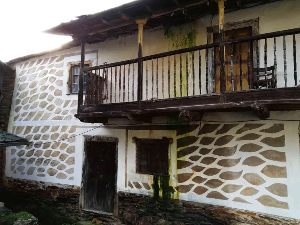 A 'casa do carteiro' ten na fachada un reboco con perpia&ntilde;os finxidos. (Foto: Proxecto R&iacute;os Adega)