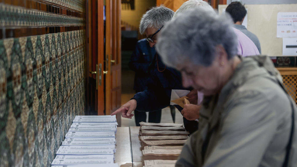 Dúas persoas collendo a papeleta durante as eleccións municipais do 28-M. (Foto: Ricardo Rubio / Europa Press)