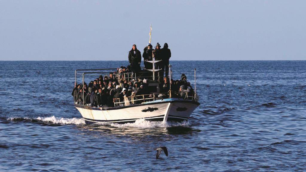 Un grupo de migrantes nunha embarcación no mar Mediterráneo tentando chegar ás costas do Estado italiano. (Foto: Cremaschi / Insidefoto / Ropi / Zuma Press)