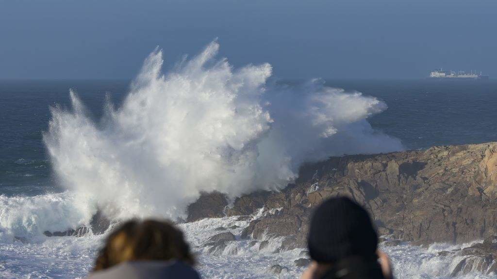 Dúas persoas ven romper as ondas na Coruña. (Foto: M. Dylan / Europa Press)