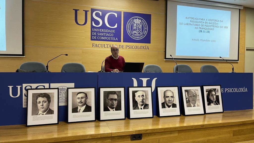Manuel Filgueira xunto aos retratos de Luis André, Díaz Rozas, Iglesias Vilarelle, Filgueira González, Lozano Zuza e Pardo Múgica. (Foto: Nós Diario).