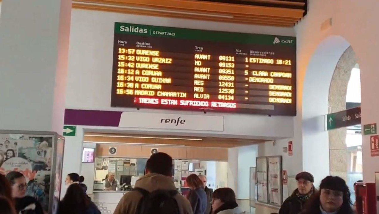 Cartel advertindo do atraso dos trens que saen e chegan á Coruña na estación de Santiago, ás 16 horas de hoxe. (Foto: Nós Diario)