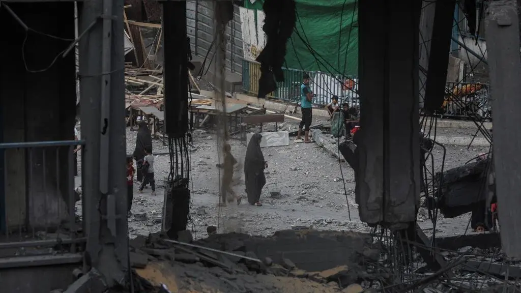 Varias persoas inspeccionando antonte as ru&iacute;nas da escola Al-Falah, na Cidade de Gaza, tras os &uacute;ltimos ataques de Israel. (Foto: Omar Ashtawy / APA Images v&iacute;a ZUMA)