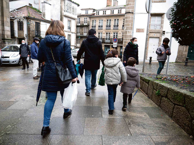 Unha familia pasea polas rúas de Compostela nas festas. (Foto: Arxina)